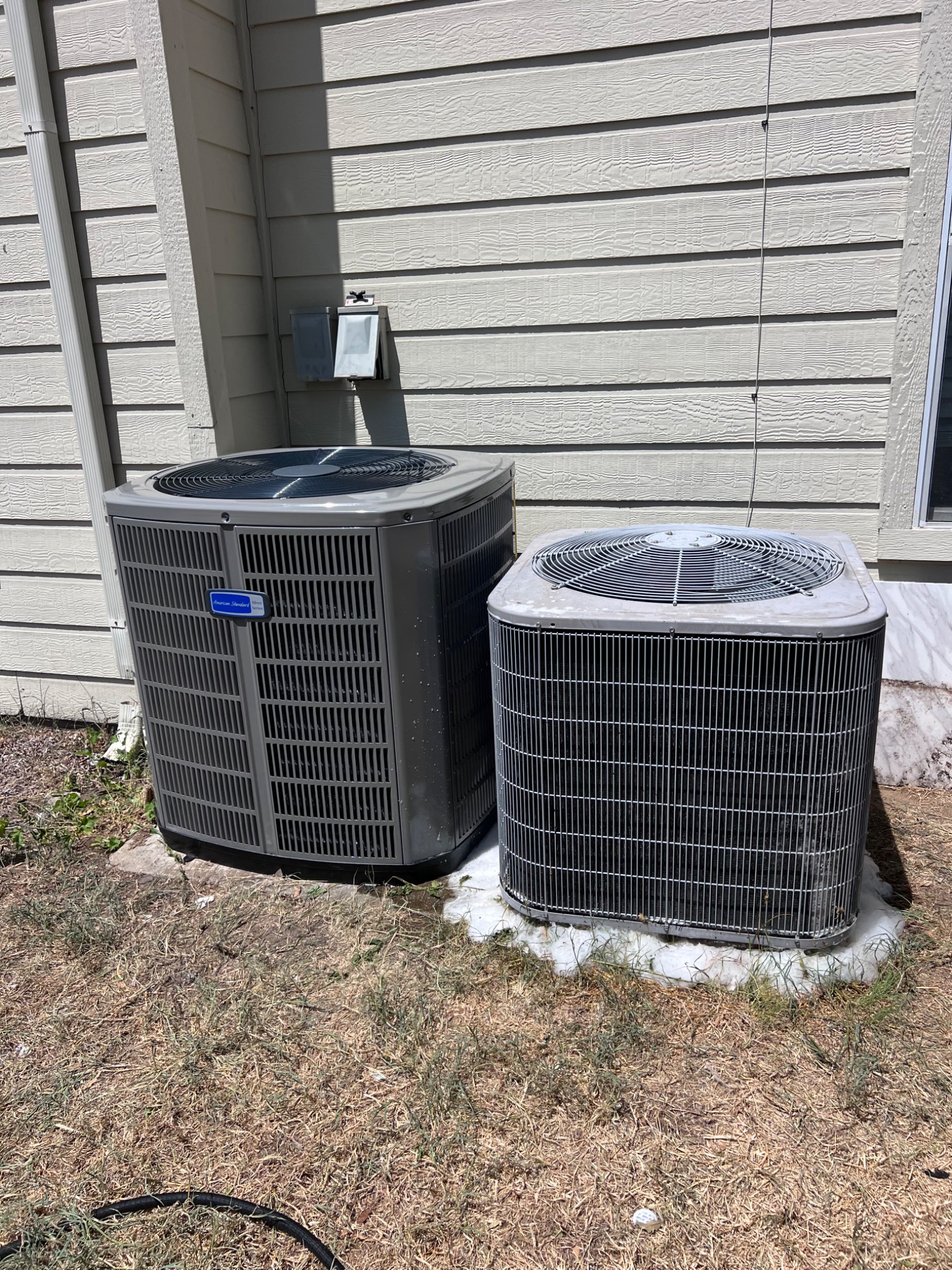 New outdoor HVAC system beside existing condenser