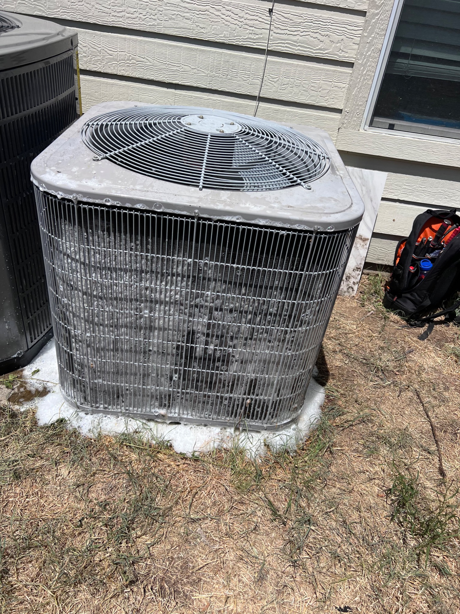 Existing outdoor condenser before HVAC replacement